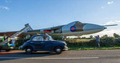 World-famous bomber overshoots runway and just misses road as cars pass