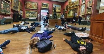 Environmental activists stage 'die in' protest at art gallery