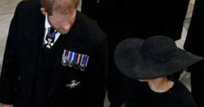 Meghan Markle comforts emotional Prince Harry as they hold hands leaving Queen's funeral