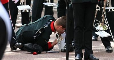 Soldier collapses and two military personnel helped away in Queen's funeral procession