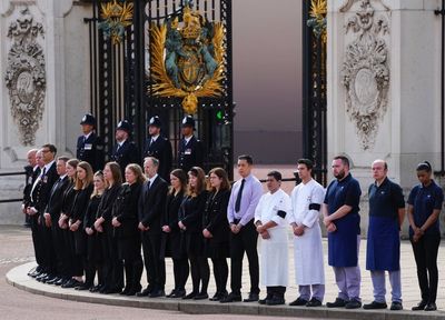 Buckingham Palace staff line up outside gates to pay respects to Queen