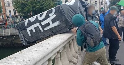 Irish anti-monarchy protesters throw coffin into river to mark 'death of British Empire'