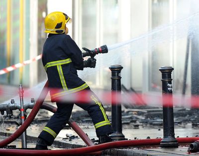 Dozens of firefighters stop supermarket fire spreading to school