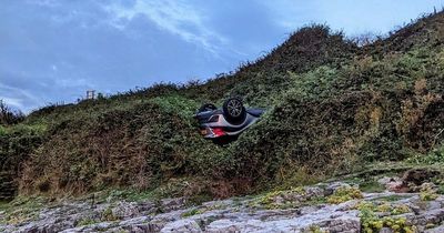 Car ends up upside down after rolling off cliff at beachside car park