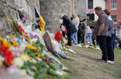 Mourners leave floral tributes to the Queen at Windsor Castle