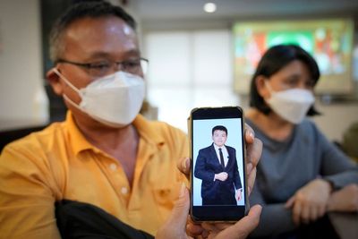 Malaysian dad pleads help for scam victims after son died