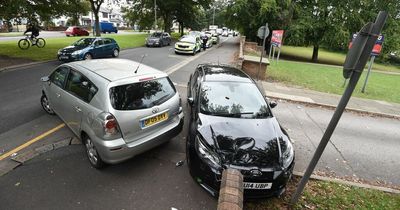 Two men abandon suspected stolen car after crash outside school