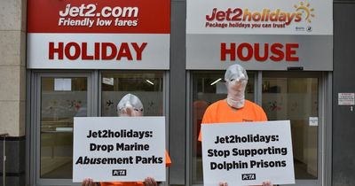 Chained-up 'dolphins' protest outside Leeds Jet 2 office