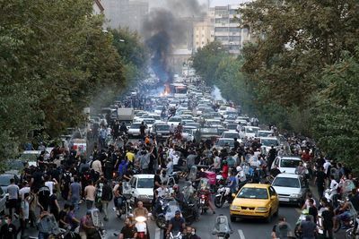 At least 9 killed as Iran protests spread over woman's death