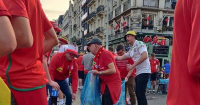 Wales football fans pictured cleaning up Belgian streets after partying as locals bowled over