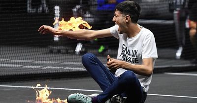 Laver Cup play halted as invader sets himself on fire before being dragged off court