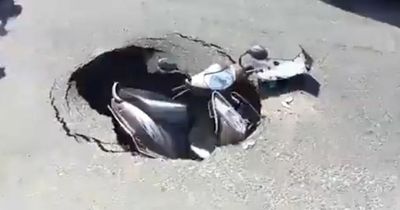 Man has extremely lucky escape as motorbike sucked into massive SINKHOLE