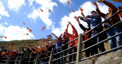 Tynemouth skies filled with orange paper planes in protest against Rwandan refugee plans
