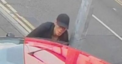 Horror CCTV shows woman knocked to the ground by her own car as brazen thief drives off