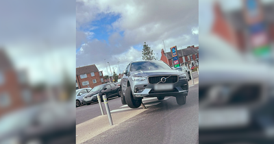 Volvo left hanging after driver gets stuck on pole in Aldi car park