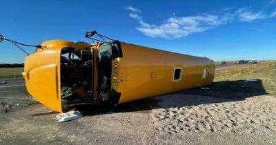 School bus flips onto side injuring 11 children after it crashes into huge truck