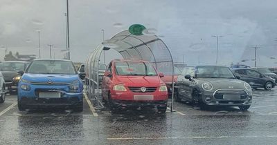 'Maybe a leaky roof?' Locals crack jokes as Asda shopper parks car up in trolley bay