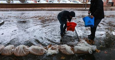 Staff cleared flood water from restaurant as wind and rain caused by Hurricane Ian hits