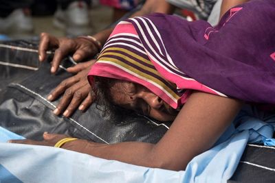 Farm vehicle packed with people overturns in India; 26 dead
