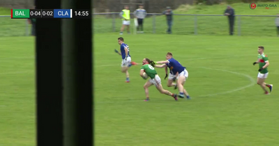 Mayo footballer Padraig O'Hora appears to have his hair pulled during club game