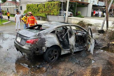 Swedish driver helped out of burning car