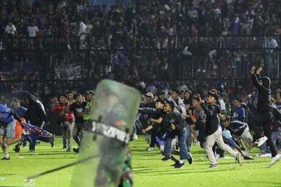 Indonesia stadium crush: Fans ‘died in the arms of players’ as child death toll rises to 32