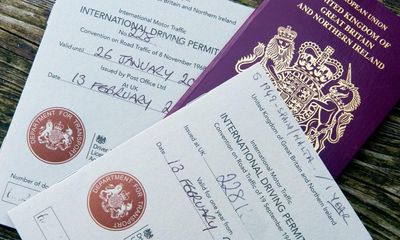 Why did I need an international permit to collect a hire car in Spain?