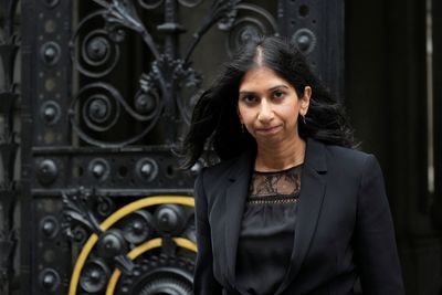 UK interior minister accuses some Conservatives of "coup" over tax rate