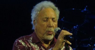 Tom Jones, 82, sparks health concerns as he performs concert sat down clutching a cane