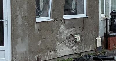 Car smashes into shop building leaving wrecked wall