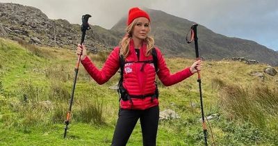 Amanda Holden celebrates after battling through 'wind and snow' to climb Snowdon during Three Peaks Challenge