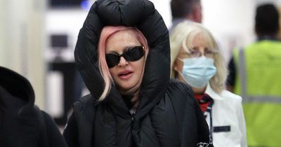 Madonna looks fresh-faced after flight as she rocks £755 designer crocs and pink hair