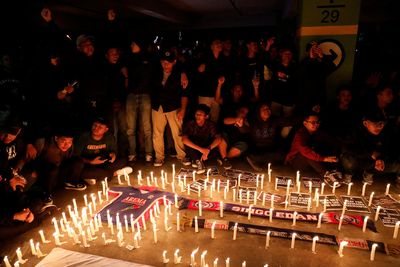 Fans mourn victims of Indonesian stadium crush at Friday prayers