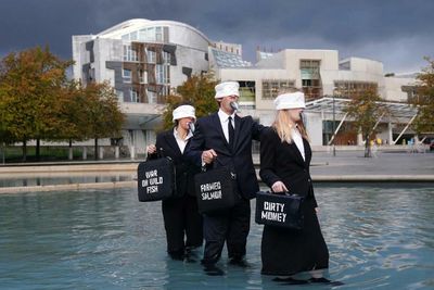 Campaigners stage protest against caged salmon farming outside Holyrood