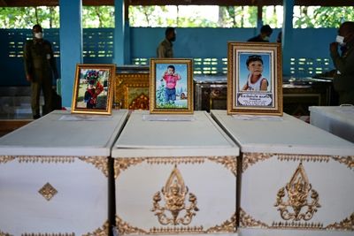Thai king tells massacre victims' families 'I share your grief'