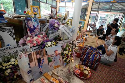 Mourners pray at Thai temple filled by children's keepsakes
