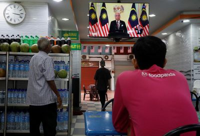 Malaysian PM calls for early polls as ruling party seeks to rise above graft cases