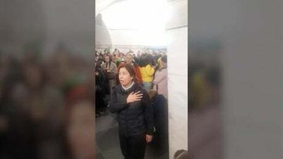 Ukrainians sing national anthem whilst sheltering under a subway station
