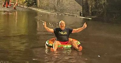 Dad-of-five sick of floods on busy road takes a dip with rubber ring in huge puddle