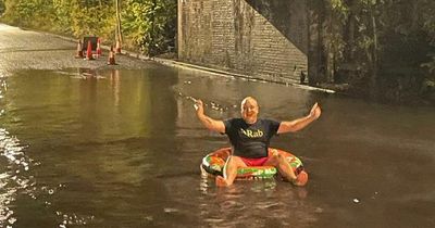 Dad fed up with flooding takes £5 rubber ring for a dip in giant puddle on busy road