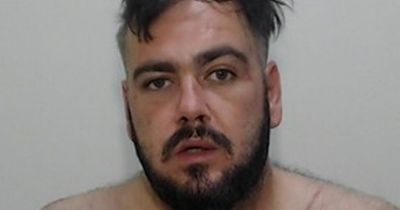 Topless mugshot of suspect 'deemed a high risk to women' who is being hunted by police