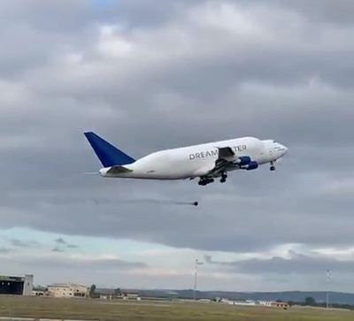Moment a 100kg wheel falls off massive Boeing Dreamlifter jet