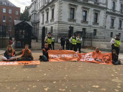 Scottish activists glue themselves outside Downing Street in climate protest