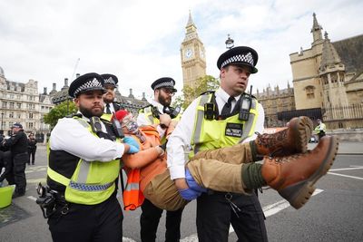 Police arrest activists who glued themselves to road outside Parliament