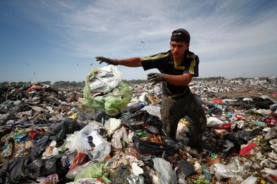Turning to garbage dumps to survive, Argentines feel the pain of 100% inflation