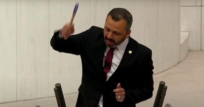Politician smashes his own phone with a HAMMER while speaking in parliament