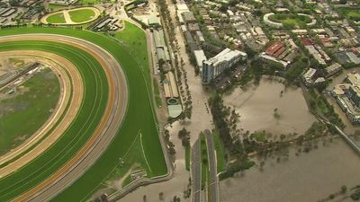 As Melbourne clean-up begins, concerns raised over whether Flemington Racecourse wall exacerbated flooding