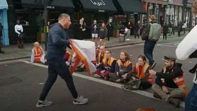 Public clash with Just Stop Oil protesters blocking east London road