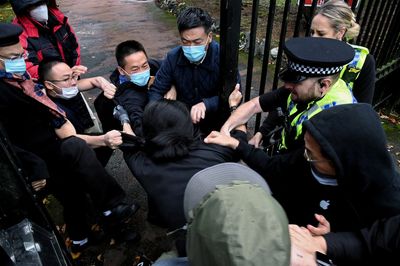 British police probe beating of protester on China consulate grounds