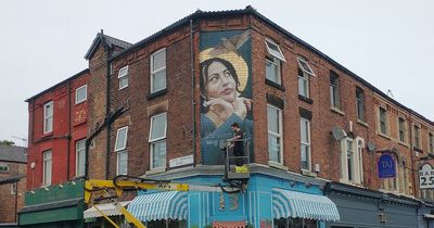 Story behind 'Lady of Lark Lane' mural above shop on city street